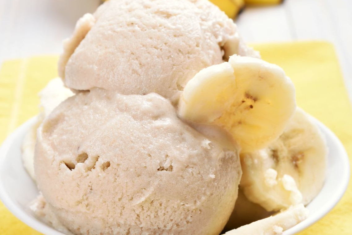 Two scoops of ice cream with banana slices