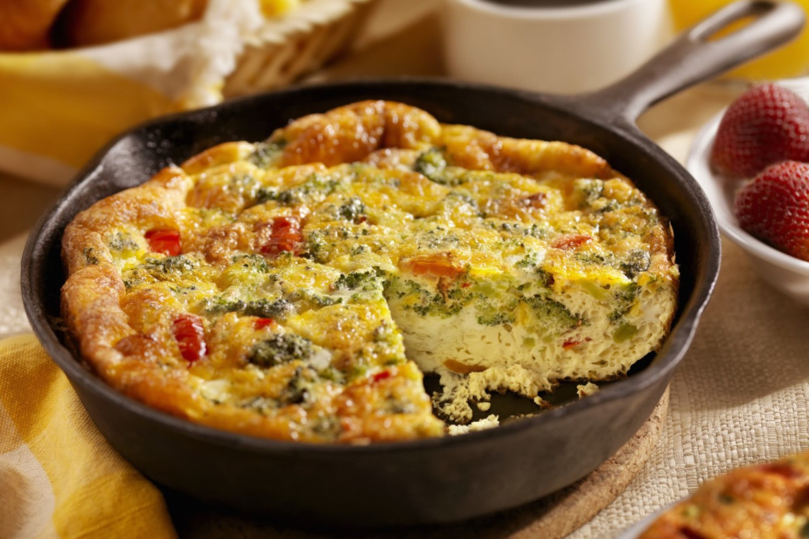 A skillet with a baked quiche