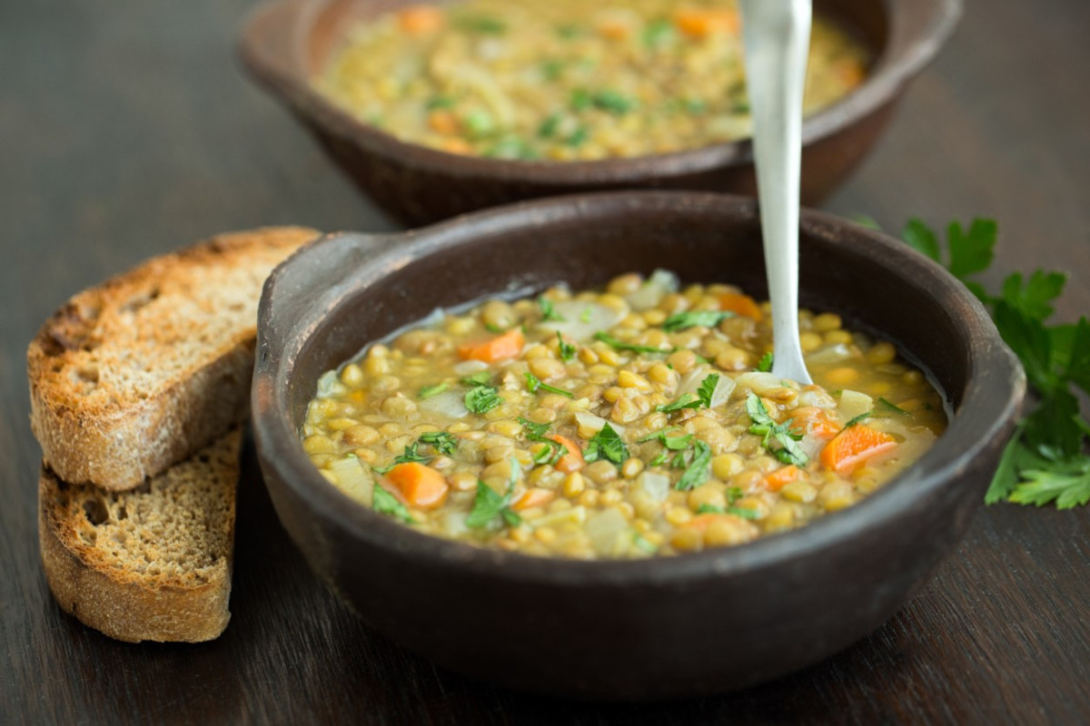 A bowl of lentil soup with toasted bread